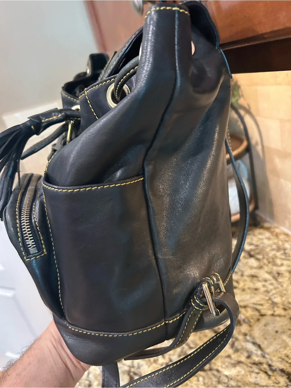 Dooney & Bourke Black Leather Drawstring Backpack with Yellow Stitching